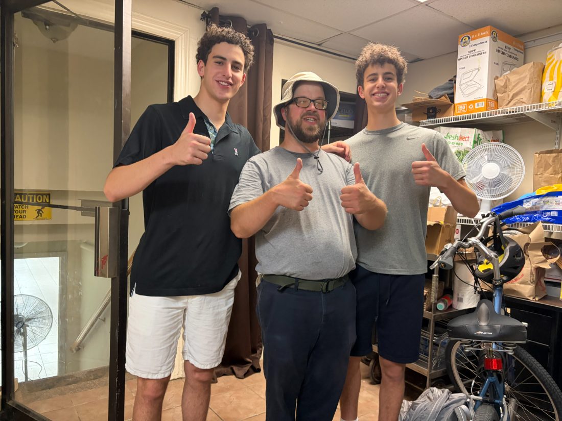 Daniel and Liam giving a thumbs up with a CSA Kitchen volunteer