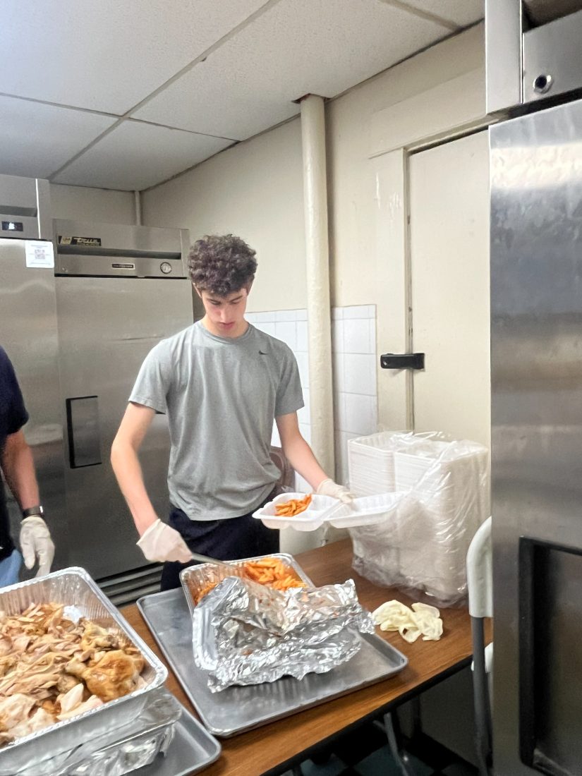 Daniel plating penne into a takeout container