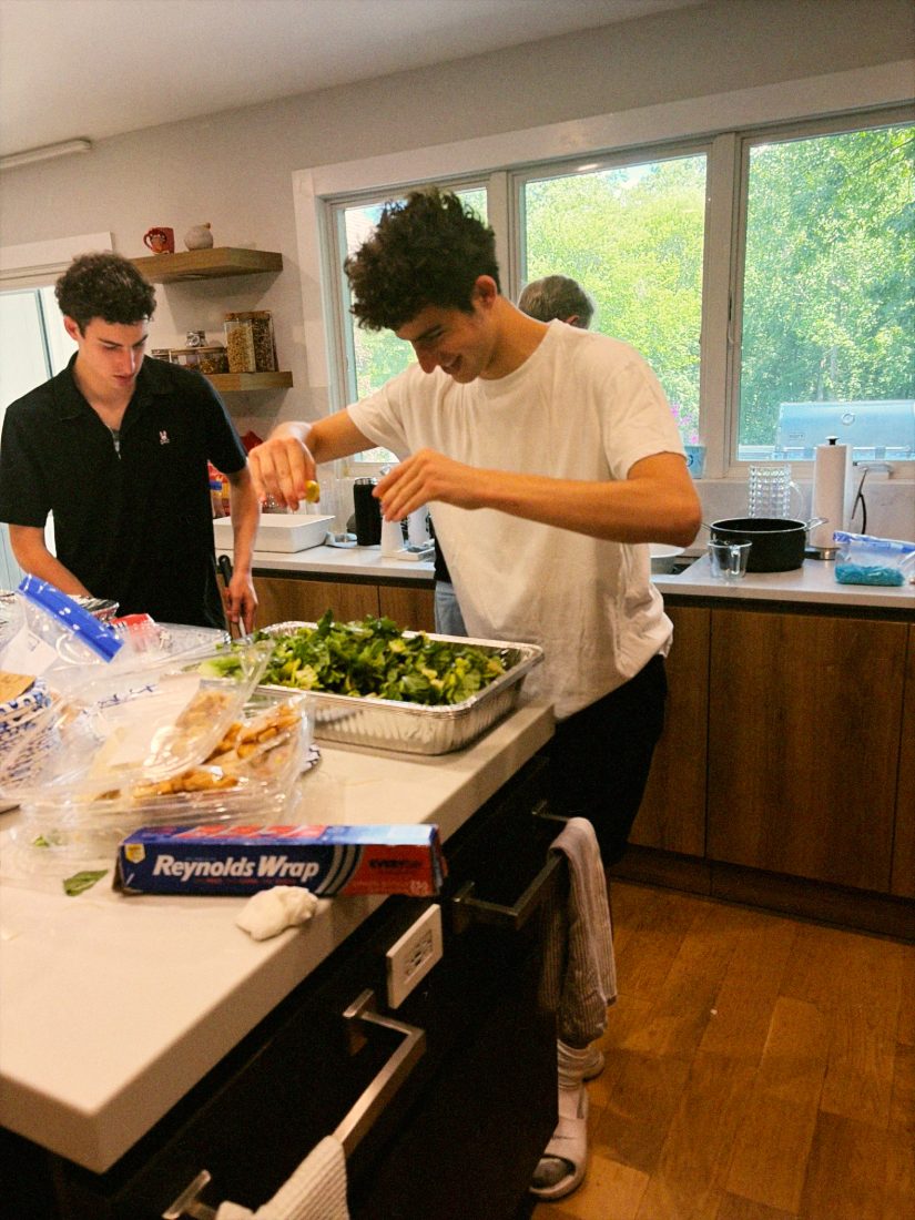 Daniel and Liam prepping salad trays together