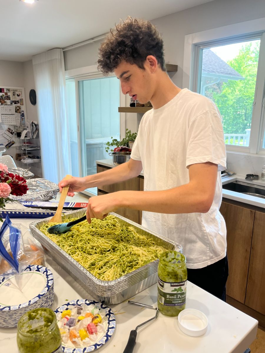 Fresh pesto pasta prepared in a large tray